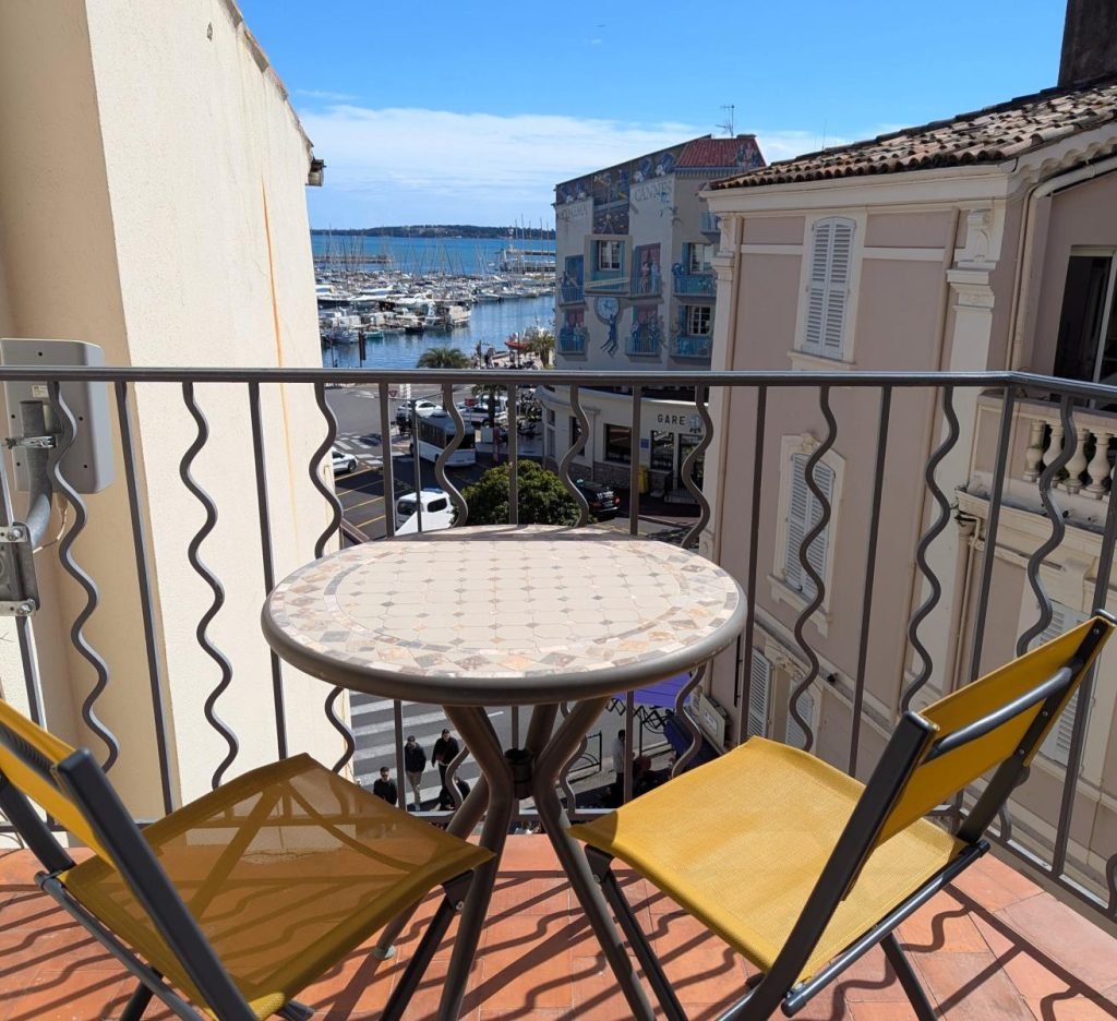 Beautiful panoramic balcony overlooking the Old Port of Cannes and Palais des Festivals to the left.